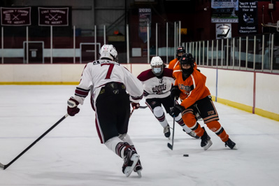 Plattbsurgh captain enters the offensive zone as Northeastern Clinton's Jack Bulson steps up to chal